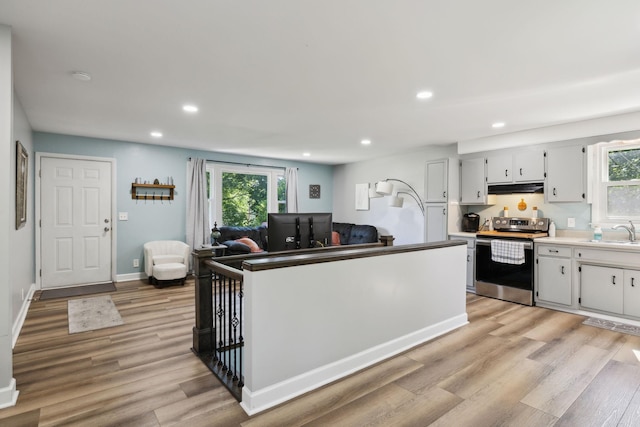 221 Cedar Creek Dr, Mount Juliet, TN 37122 - kitchen featuring stainless steel range with electric stovetop, under cabinet range hood, light wood-style floors, a sink, and recessed lighting