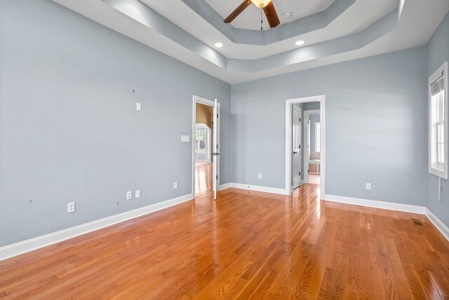767 Dixie Ln, Pleasant View, TN 37146 - empty room featuring a raised ceiling, ceiling fan, baseboards, light wood-style flooring, and recessed lighting