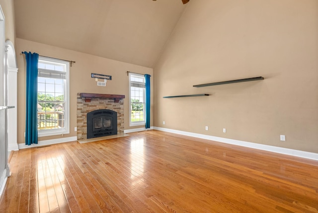 767 Dixie Ln, Pleasant View, TN 37146 - unfurnished living room featuring light wood-type flooring, baseboards, ceiling fan, high vaulted ceiling, and a fireplace