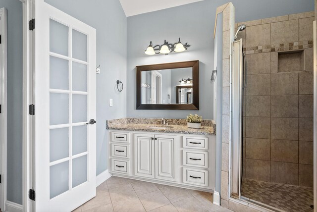 767 Dixie Ln, Pleasant View, TN 37146 - bathroom featuring a shower stall, vanity, tile patterned flooring, and baseboards