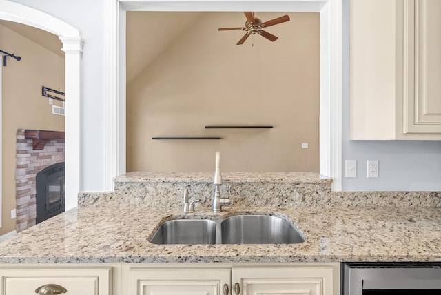 767 Dixie Ln, Pleasant View, TN 37146 - kitchen with a sink, wine cooler, a ceiling fan, lofted ceiling, and light stone counters
