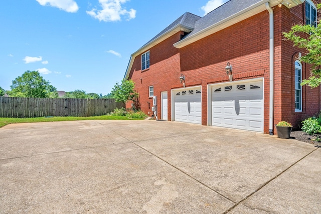 767 Dixie Ln, Pleasant View, TN 37146 - view of home's exterior with driveway, brick siding, roof with shingles, and an attached garage