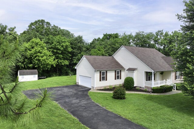 2815 Windy Way, Thompsons Station, TN 37179 - view of front of house featuring asphalt driveway, a front lawn, covered porch, a shingled roof, and a storage unit