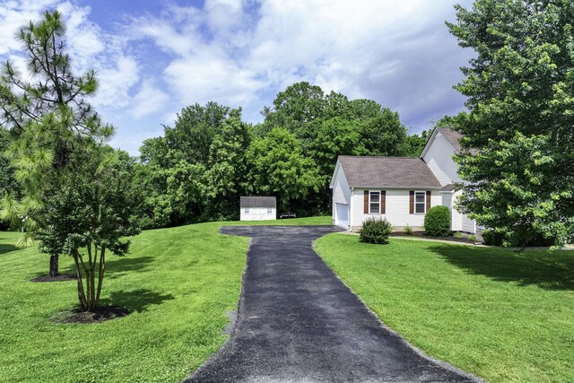 2815 Windy Way, Thompsons Station, TN 37179 - view of front of house featuring a front lawn, roof with shingles, and an outdoor structure