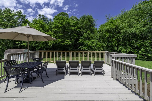 2815 Windy Way, Thompsons Station, TN 37179 - deck with outdoor dining space, an outdoor structure, and view of wooded area