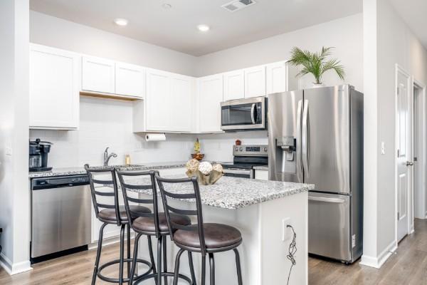 166 Grayson Cir, Chapel Hill, TN 37034 - kitchen featuring stainless steel appliances, light wood-type flooring, white cabinetry, a breakfast bar area, and recessed lighting