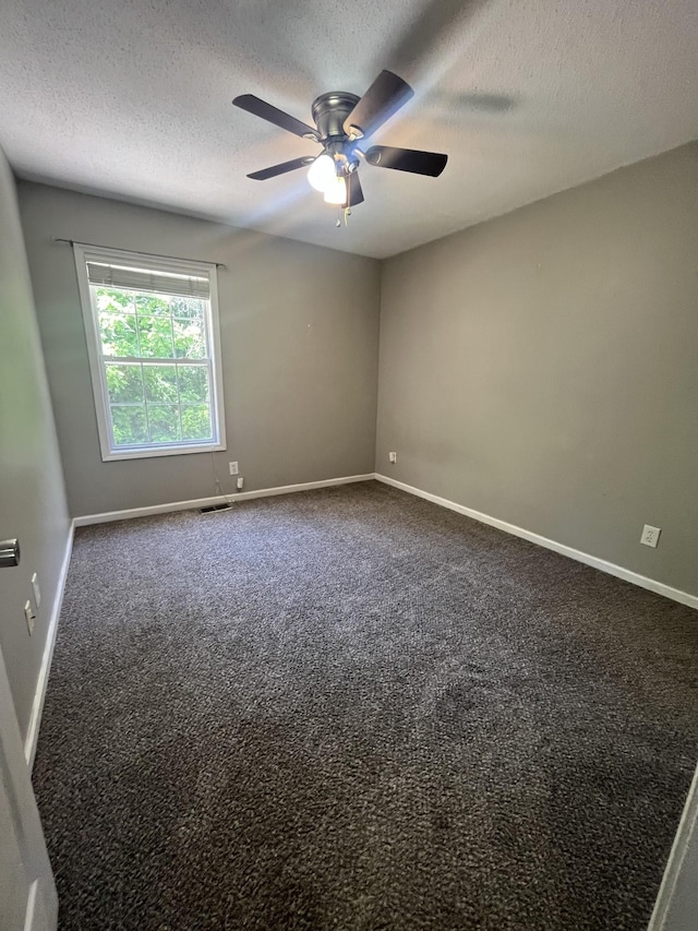 924 Granny White Rd, Clarksville, TN 37040 - empty room with ceiling fan, dark colored carpet, a textured ceiling, and baseboards