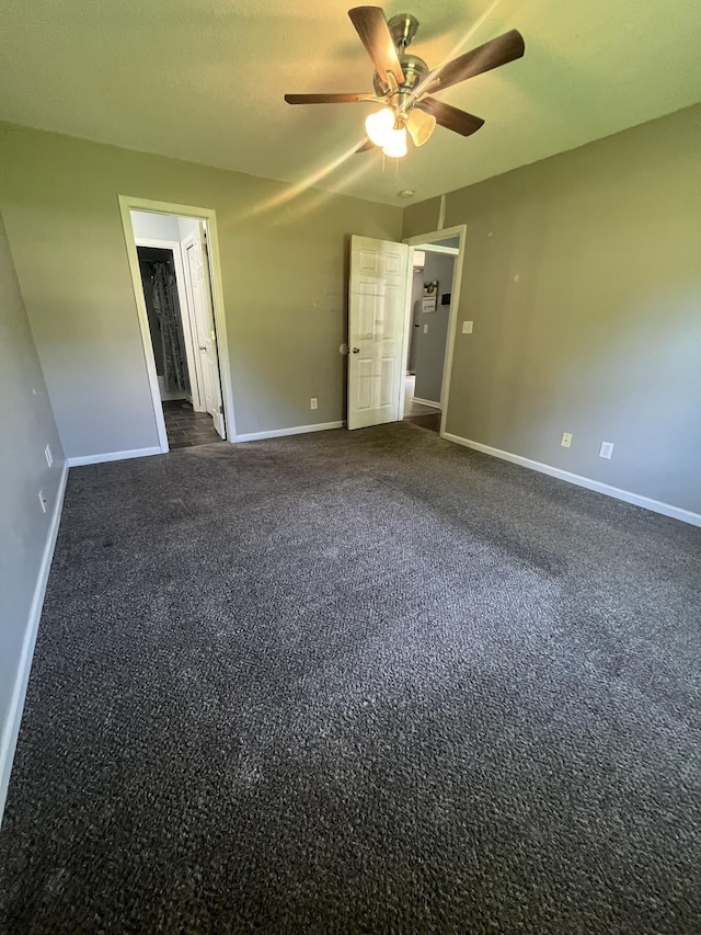 924 Granny White Rd, Clarksville, TN 37040 - unfurnished bedroom featuring dark carpet, baseboards, and a ceiling fan
