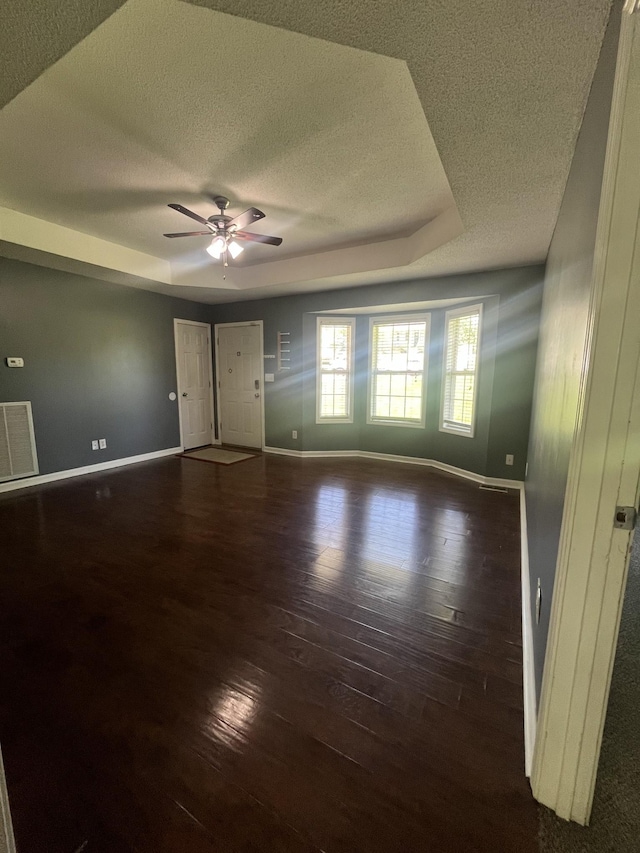 924 Granny White Rd, Clarksville, TN 37040 - unfurnished room with a textured ceiling, baseboards, hardwood / wood-style floors, a ceiling fan, and a tray ceiling