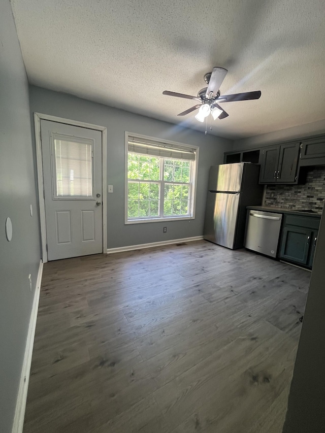 924 Granny White Rd, Clarksville, TN 37040 - kitchen with stainless steel appliances, a textured ceiling, wood finished floors, ceiling fan, and tasteful backsplash