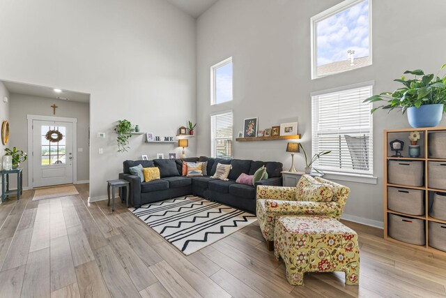 360 Gulfstream Dr, Gallatin, TN 37066 - living room featuring a towering ceiling, wood finished floors, and baseboards