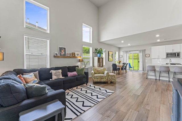 360 Gulfstream Dr, Gallatin, TN 37066 - living room featuring light wood finished floors, a high ceiling, and recessed lighting