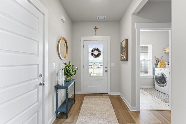 360 Gulfstream Dr, Gallatin, TN 37066 - entryway with washer / dryer, light wood-style flooring, plenty of natural light, and baseboards