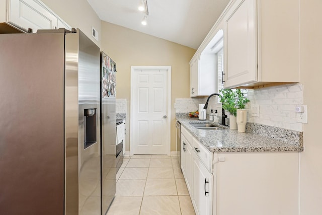 3408 Bruner Ct, Nashville, TN 37211 - kitchen featuring stainless steel appliances, a sink, vaulted ceiling, tasteful backsplash, and white cabinetry