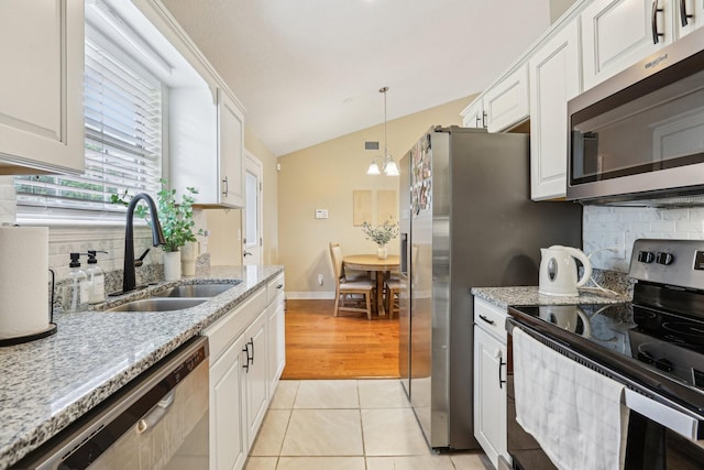 3408 Bruner Ct, Nashville, TN 37211 - kitchen featuring stainless steel appliances, a sink, vaulted ceiling, tasteful backsplash, and white cabinetry