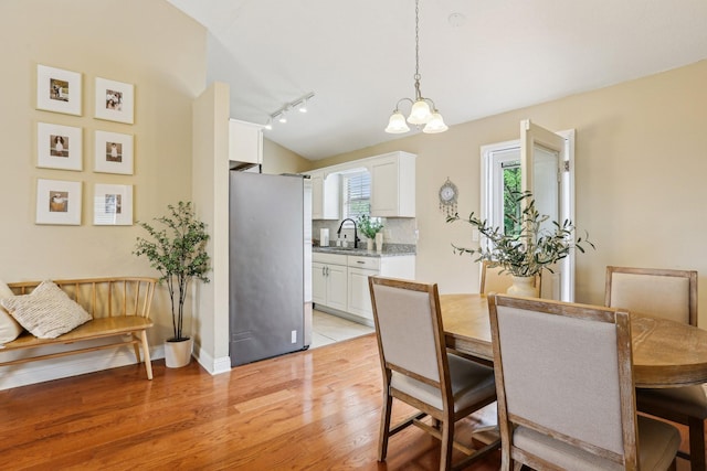 3408 Bruner Ct, Nashville, TN 37211 - dining space with light wood-style floors, rail lighting, a chandelier, and baseboards
