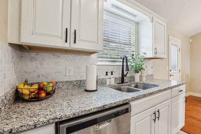 3408 Bruner Ct, Nashville, TN 37211 - kitchen with a sink, stainless steel dishwasher, white cabinetry, wood finished floors, and tasteful backsplash