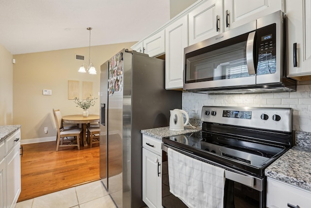 3408 Bruner Ct, Nashville, TN 37211 - kitchen with appliances with stainless steel finishes, a chandelier, decorative backsplash, white cabinets, and light stone counters