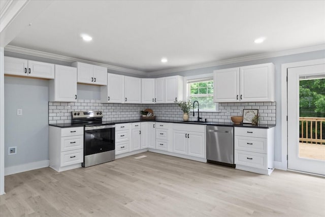 244 Beartown Rd S, Loretto, TN 38469 - kitchen with appliances with stainless steel finishes, a sink, crown molding, dark countertops, and white cabinets
