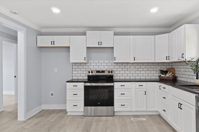 244 Beartown Rd S, Loretto, TN 38469 - kitchen featuring electric range, ornamental molding, dark countertops, light wood-style floors, and white cabinetry