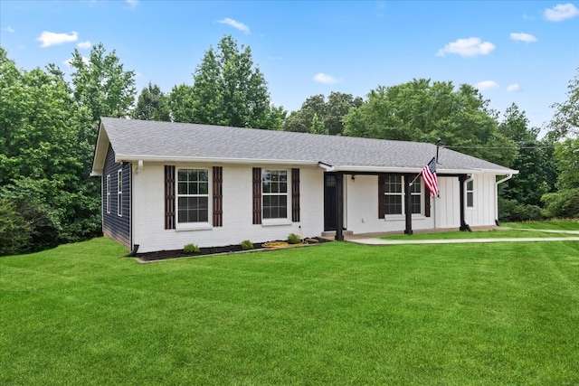 244 Beartown Rd S, Loretto, TN 38469 - ranch-style home with a front lawn, brick siding, roof with shingles, and board and batten siding