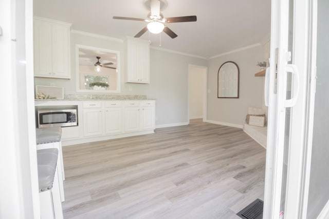 204 Tyne Blvd, Old Hickory, TN 37138 - kitchen with stainless steel microwave, a ceiling fan, crown molding, white cabinetry, and light wood-type flooring