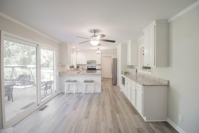 204 Tyne Blvd, Old Hickory, TN 37138 - kitchen featuring appliances with stainless steel finishes, a peninsula, light wood-style floors, ceiling fan, and white cabinets