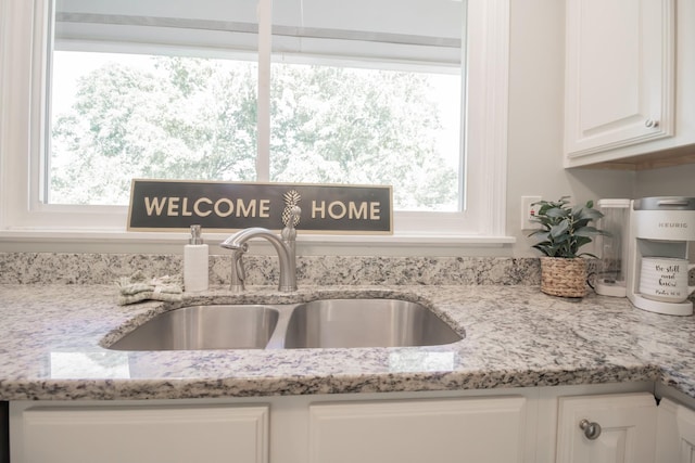 204 Tyne Blvd, Old Hickory, TN 37138 - kitchen view of a sink, white cabinetry, and light stone countertops