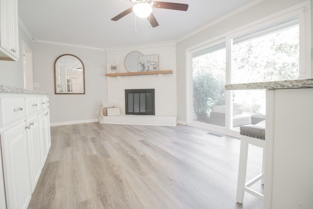 204 Tyne Blvd, Old Hickory, TN 37138 - unfurnished living room with ceiling fan, ornamental molding, light wood finished floors, a brick fireplace, and baseboards