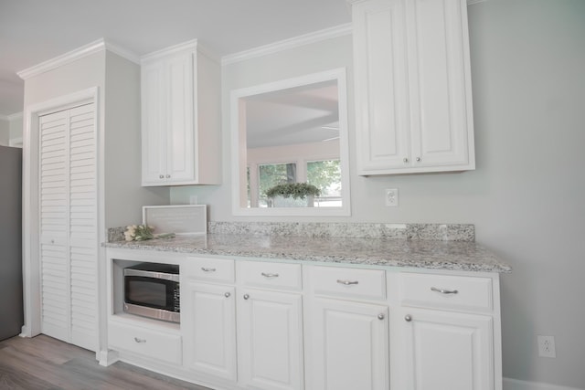 204 Tyne Blvd, Old Hickory, TN 37138 - kitchen featuring stainless steel appliances, white cabinets, crown molding, light stone countertops, and wood finished floors