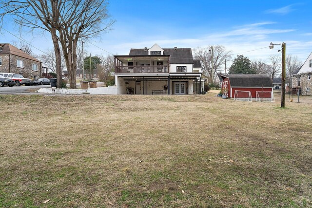 1211 Stratford Ave, Nashville, TN 37216 - view of green lawn with french doors and an outbuilding