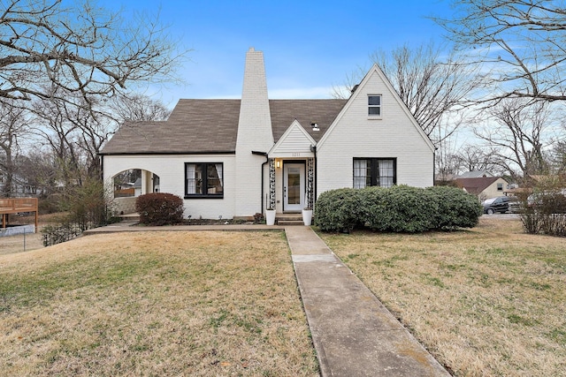 1211 Stratford Ave, Nashville, TN 37216 - view of front of property featuring a front yard, a chimney, and brick siding