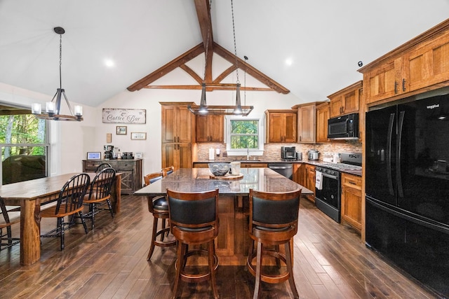100 Station Dr, Waverly, TN 37185 - kitchen with black appliances, brown cabinets, a kitchen island, dark wood-type flooring, and beamed ceiling