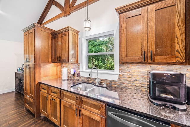 100 Station Dr, Waverly, TN 37185 - kitchen with stainless steel dishwasher, brown cabinets, dark stone countertops, a sink, and decorative backsplash