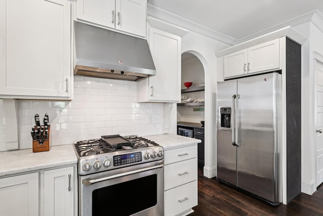 2809 Vaulx Ln, Nashville, TN 37204 - kitchen featuring appliances with stainless steel finishes, under cabinet range hood, dark wood-type flooring, white cabinets, and crown molding