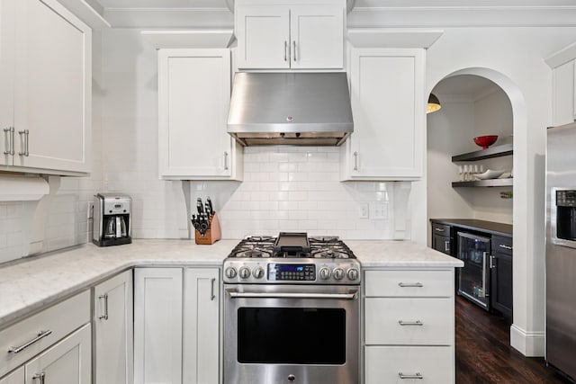 2809 Vaulx Ln, Nashville, TN 37204 - kitchen featuring under cabinet range hood, stainless steel appliances, beverage cooler, white cabinetry, and decorative backsplash