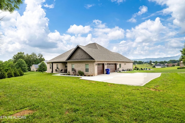 837 Majestic Mountains Blvd, Walland, TN 37886 - rear view of property featuring a lawn, a garage, brick siding, driveway, and a shingled roof