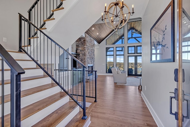 337 Lake Court Dr, Lynchburg, TN 37352 - entryway with high vaulted ceiling, a chandelier, wood finished floors, baseboards, and stairs
