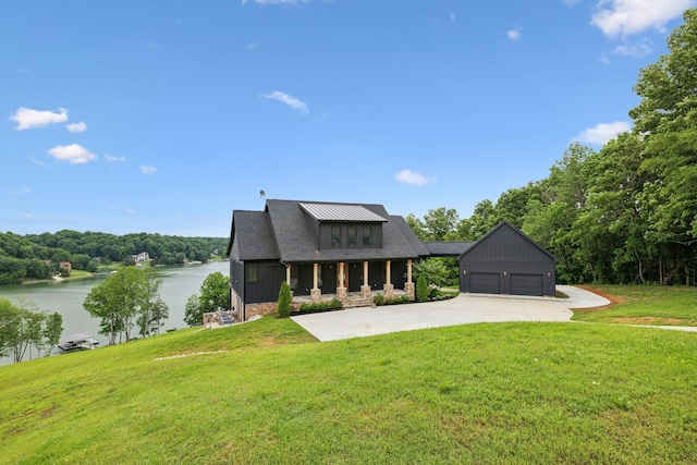 337 Lake Court Dr, Lynchburg, TN 37352 - modern farmhouse featuring a water view, a front lawn, a garage, and concrete driveway