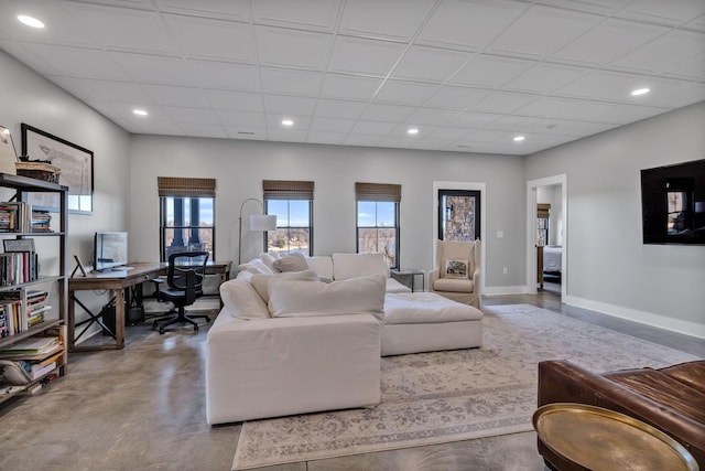 337 Lake Court Dr, Lynchburg, TN 37352 - living area with finished concrete flooring, a desk, baseboards, and recessed lighting