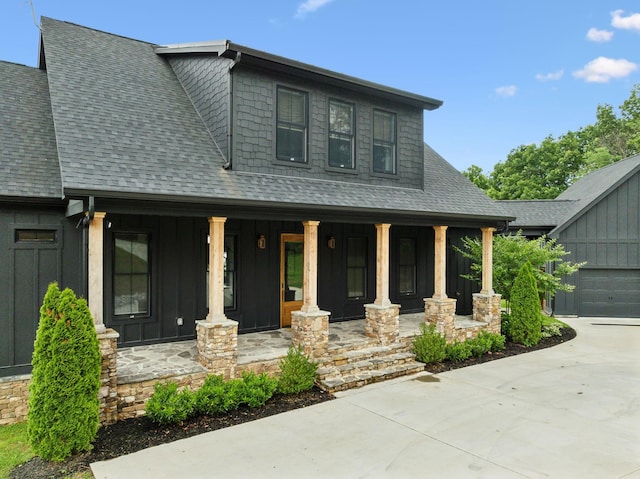337 Lake Court Dr, Lynchburg, TN 37352 - view of front facade featuring a porch, board and batten siding, roof with shingles, and concrete driveway