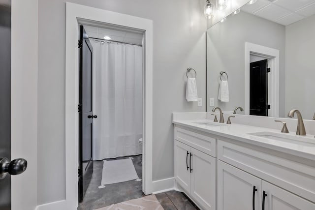 337 Lake Court Dr, Lynchburg, TN 37352 - full bath with double vanity, toilet, baseboards, and a shower with shower curtain