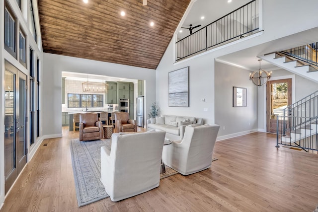 337 Lake Court Dr, Lynchburg, TN 37352 - living area with high vaulted ceiling, a chandelier, stairway, wood ceiling, and baseboards