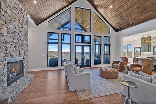 337 Lake Court Dr, Lynchburg, TN 37352 - living area with high vaulted ceiling, wood ceiling, baseboards, a stone fireplace, and wood finished floors