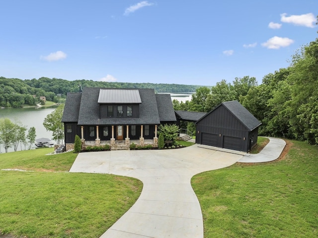 337 Lake Court Dr, Lynchburg, TN 37352 - modern farmhouse with a porch, a water view, a front yard, a detached garage, and a shingled roof