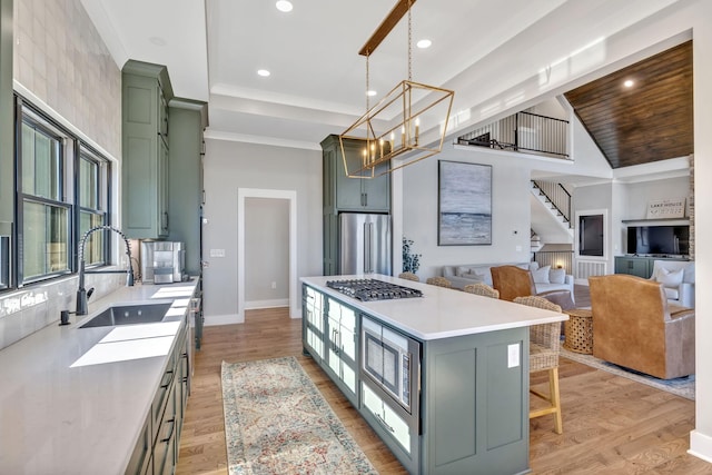 337 Lake Court Dr, Lynchburg, TN 37352 - kitchen featuring green cabinetry, stainless steel appliances, a sink, light countertops, and a center island