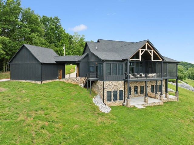 337 Lake Court Dr, Lynchburg, TN 37352 - rear view of property with a patio, a yard, stone siding, a sunroom, and a shingled roof