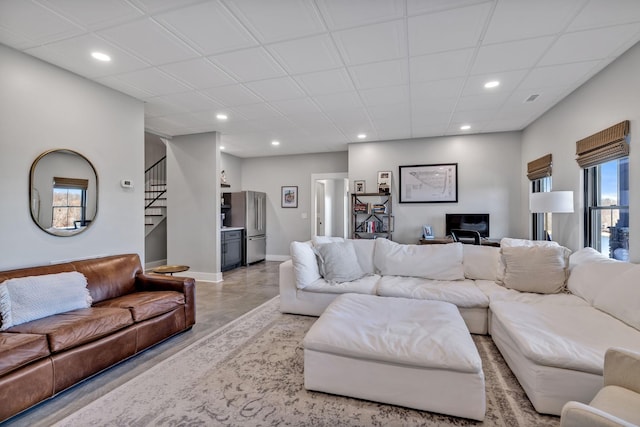 337 Lake Court Dr, Lynchburg, TN 37352 - living room featuring recessed lighting, stairs, finished concrete flooring, baseboards, and a desk