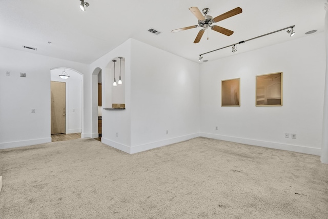 2600 Hillsboro Pike # 233, Nashville, TN 37212 - carpeted empty room featuring rail lighting, arched walkways, ceiling fan, and baseboards