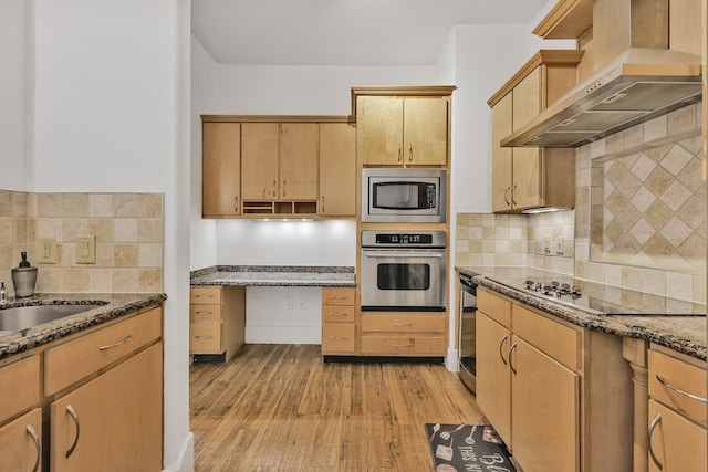 2600 Hillsboro Pike # 233, Nashville, TN 37212 - kitchen with stainless steel appliances, wall chimney range hood, light wood finished floors, and dark stone countertops